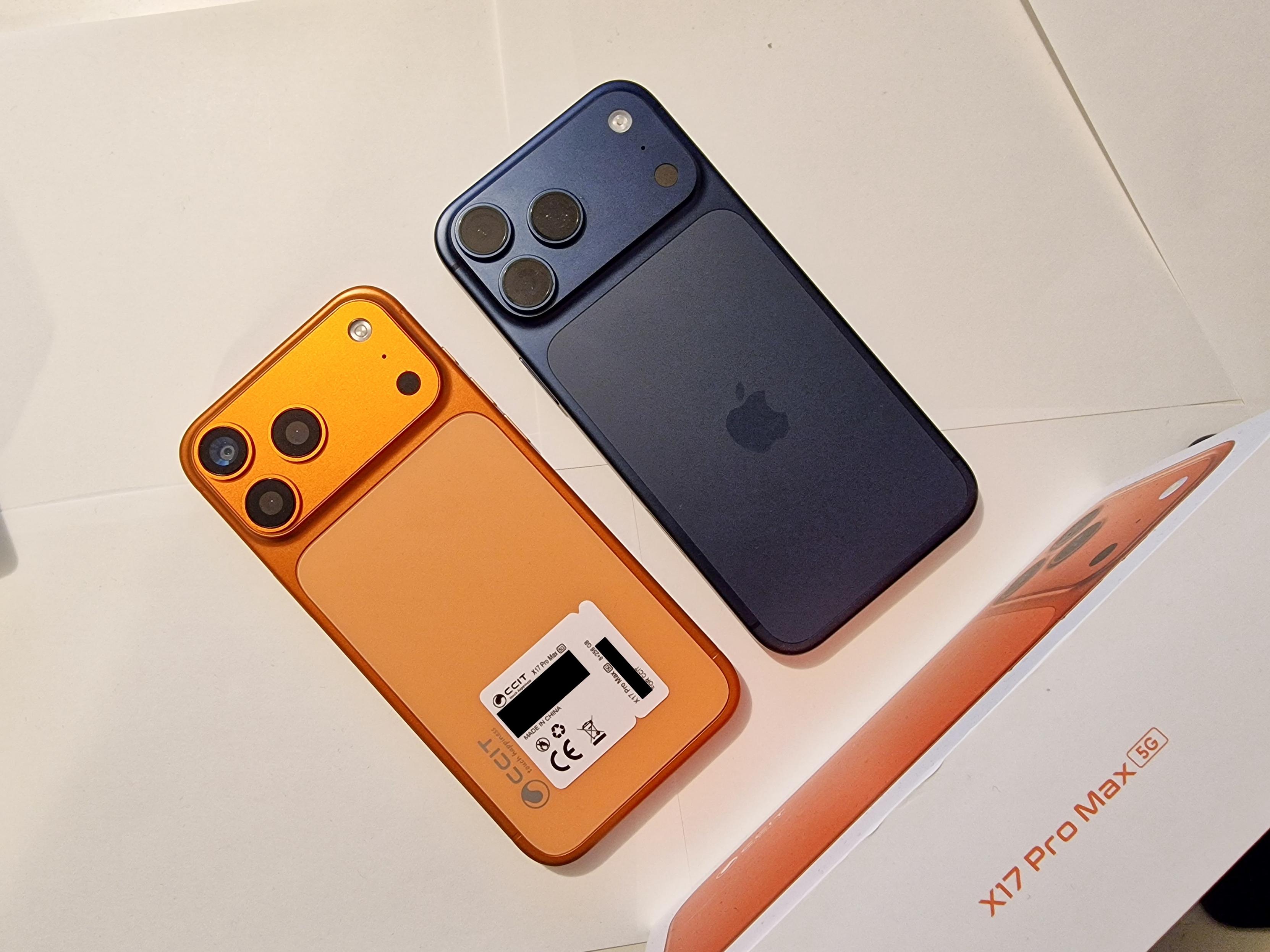 Zwei Telefone liegen nebeneinander. Sie sehen fast identisch aus, nur dass das eine orange ist und das andere dunkelblau. Auf dem orangen steht CCIT auf dem blauen ist das Apple-Logo. Darunter liegt eine Box aus der X17 Pro Max 5G steht.